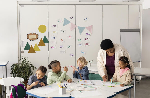 Childcare educator helping children learn in a daycare classroom