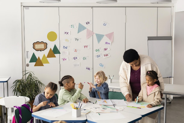 Childcare educator helping children learn in a daycare classroom