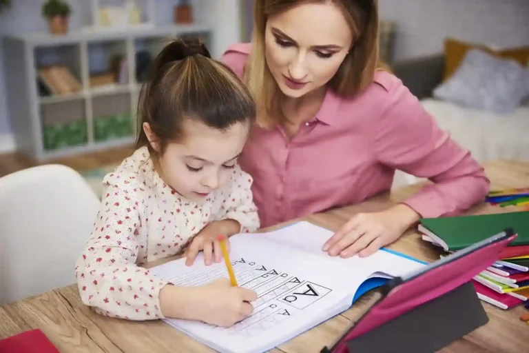 Daycare provider helping child learn.